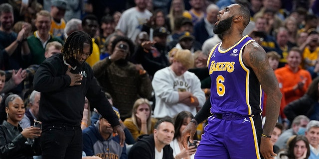 Los Angeles Lakers' LeBron James reacts after hitting a shot during overtime of in the team's NBA basketball game against the Indiana Pacers, Wednesday, Nov. 24, 2021, in Indianapolis.