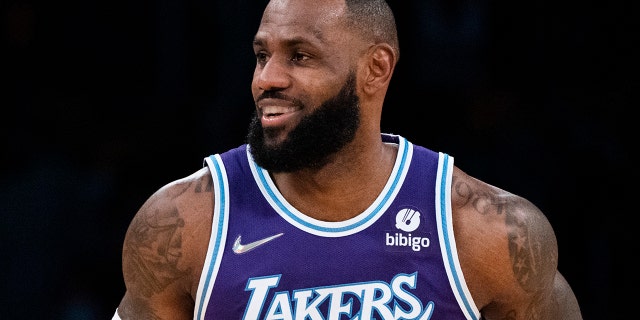 Los Angeles Lakers' LeBron James smiles as he makes his way down the court during first half of an NBA basketball game against the San Antonio Spurs Thursday, Dec. 23, 2021, in Los Angeles.