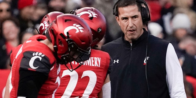 Cincinnati head coach Luke Fickell, right, stands on the sidelines during the first half of the American Athletic Conference championship NCAA college football game against Houston Saturday, Dec. 4, 2021, in Cincinnati.