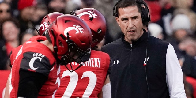 Cincinnati head coach Luke Fickell, right, stands on the sidelines during the first half of the American Athletic Conference championship NCAA college football game against Houston Saturday, Dec. 4, 2021, in Cincinnati.