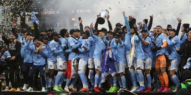 New York City FC players celebrate their penalty kick shootout win over the Portland Timbers in the MLS Cup soccer game, Saturday, Dec. 11, 2021, in Portland, Ore. (AP Photo/Amanda Loman)