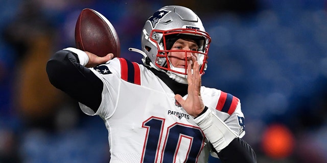 New England Patriots quarterback Mac Jones (10) looks to throw a pass during the first half of an NFL football game against the Buffalo Bills in Orchard Park, N.Y., Monday, Dec. 6, 2021.
