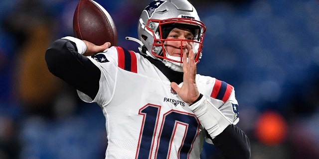 New England Patriots quarterback Mac Jones (10) looks to throw a pass during the first half of an NFL football game against the Buffalo Bills in Orchard Park, N.Y., Monday, Dec. 6, 2021.