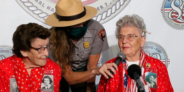 Mae Krier, right, who worked at a Boeing plant during World War II making B-17s and B-29s, speaks at a news conference in Pearl Harbor, Hawaii on Sunday, Dec. 5, 2021 accompanied by Marian Wynn, left, who worked as a pipe welder during the war.