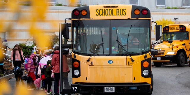 Students board buses at East End Community School in Portland, Maine.