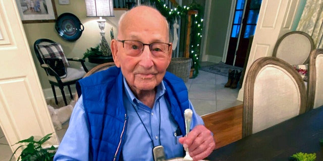 World War II veteran Major Wooten enjoys his Thanksgiving dinner with family in Madison, Alabama, on Nov. 25, 2021. (Holly McDonald via AP)