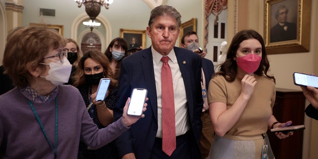 Joe Manchin, D-W.Va., is followed by reporters as he leaves a caucus meeting with Senate Democrats at the U.S. Capitol Dec. 17, 2021.