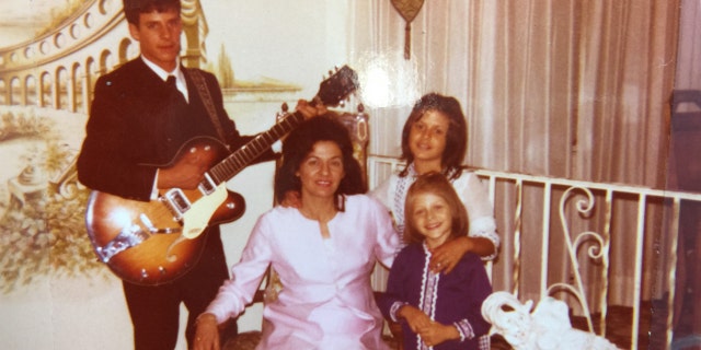 A young Maria Bartiromo (far right, front), along with her mother, Josephine, and her two older siblings, Patrick and Theresa, in a personal portrait that appears in ‘All American Christmas.’