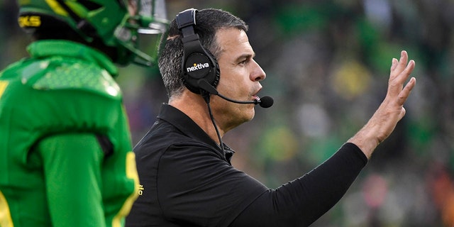Oregon head coach Mario Cristobal directs his players during the fourth quarter of an NCAA college football game against Oregon State, Saturday, Nov. 27, 2021, in Eugene, Oregon.