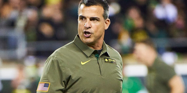 Oregon Ducks head coach Mario Cristobal watches players during warm-ups before a game against the Washington State Cougars at Autzen Stadium Nov. 13, 2021, in Eugene, Oregon.