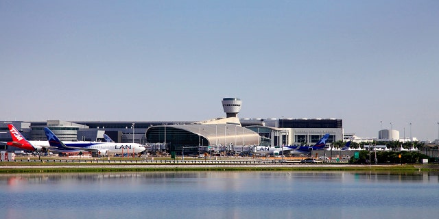 Miami, Florida, USA - May 9, 2013: Panoramic photo of the famous Miami International Airport with lots of airplanes loading and unloading passenger and cargo on May 9, 2013 in Miami, Florida, USA.
