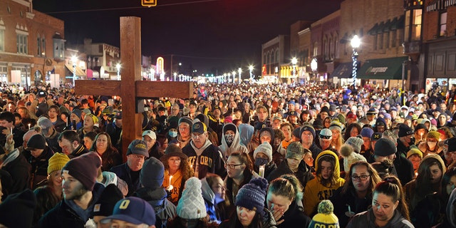 OXFORD, MICHIGAN - DECEMBER 03: People attend a vigil downtown to honor those killed and wounded during the recent shooting at Oxford High School on December 03, 2021 in Oxford, Michigan. Four students were killed and seven others injured on November 30, when student Ethan Crumbley allegedly opened fire with a pistol at the school. Crumbley has been charged in the shooting. Today his parents were also charged.  (Photo by Scott Olson/Getty Images)