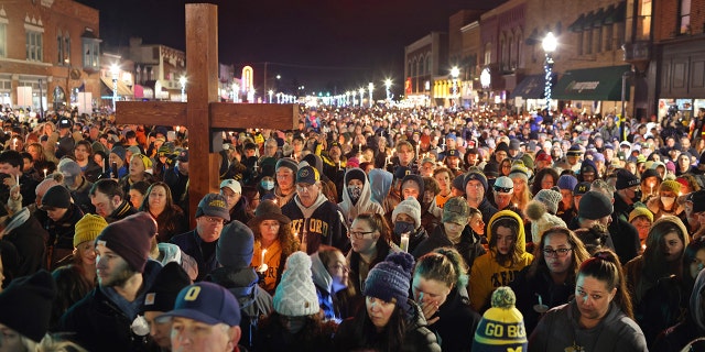 OXFORD, MICHIGAN - DECEMBER 03: People attend a vigil downtown to honor those killed and wounded during the recent shooting at Oxford High School on December 03, 2021 in Oxford, Michigan. Four students were killed and seven others injured on November 30, when student Ethan Crumbley allegedly opened fire with a pistol at the school. Crumbley has been charged in the shooting. Today his parents were also charged.  (Photo by Scott Olson/Getty Images)