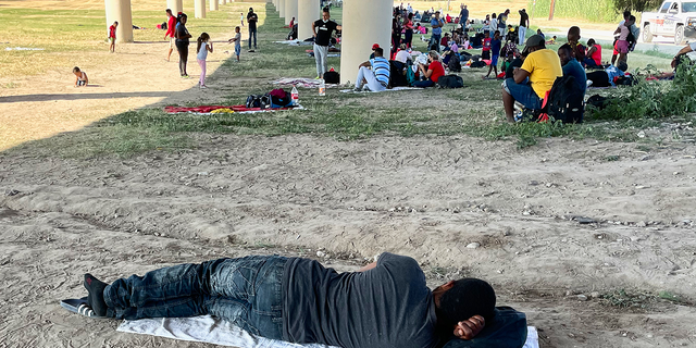 Migrants under a bridge at the Rio Grande near the Del Rio-Acuna Port of Entry in Del Rio, Texas.