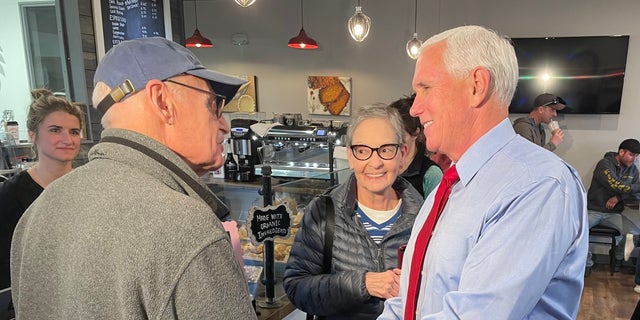 Former Vice President Mike Pence, during a trip to New Hampshire, greets customers at Simply Delicious Bakery in Bedford on Dec. 8, 2021.