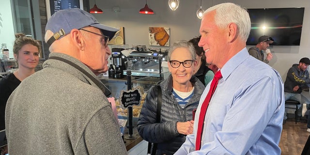 Former Vice President Mike Pence, during a trip to New Hampshire, greets customers at Simply Delicious Bakery in Bedford on Dec. 8, 2021.