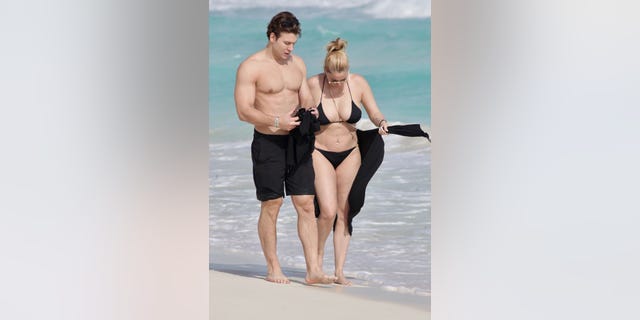 Shanna Moakler and boyfriend walk on the beach in Mexico