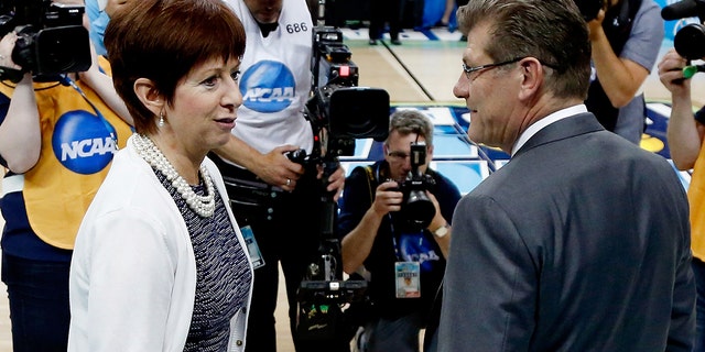 TAMPA, FL - APRIL 07: Head coach Muffet McGraw of the Notre Dame Fighting Irish (L) and head coach Geno Auriemma of the Connecticut Huskies meet prior to the start of the NCAA Women's Final Four National Championship at Amalie Arena on April 7, 2015 in Tampa, Florida. 