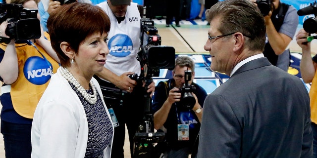 TAMPA, FL - APRIL 07: Head coach Muffet McGraw of the Notre Dame Fighting Irish (L) and head coach Geno Auriemma of the Connecticut Huskies meet prior to the start of the NCAA Women's Final Four National Championship at Amalie Arena on April 7, 2015 in Tampa, Florida.