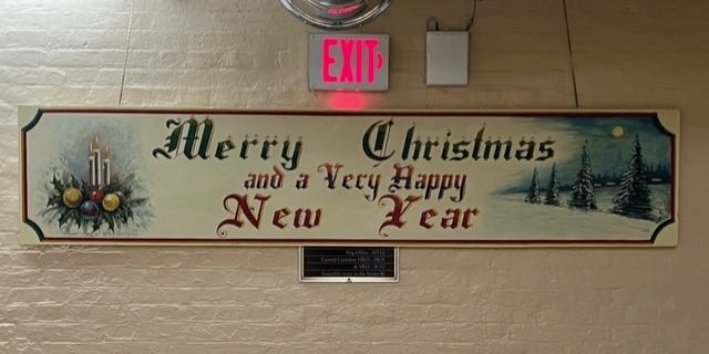 Every year a beautiful mural emerges in an obscure, basement hallway of the Capitol. "Merry Christmas," declares the long, wooden mural in evergreen paint and an Olde English font. "And a very happy New Year." 