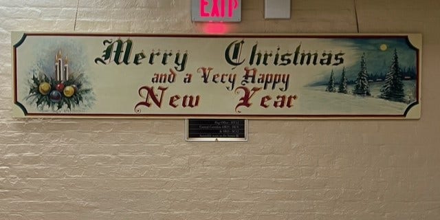 Every year a beautiful mural emerges in an obscure, basement hallway of the Capitol. "Merry Christmas," declares the long, wooden mural in evergreen paint and an Olde English font. "And a very happy New Year." 