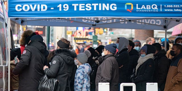 People queue at a popup COVID-19 testing site as the omicron coronavirus variant continues to spread in Manhattan, New York City, on Dec. 27, 2021. 