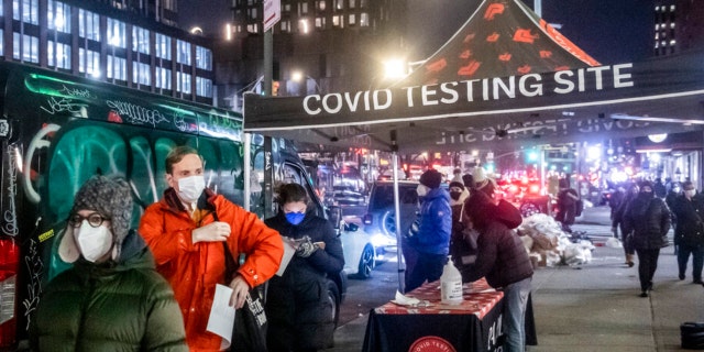 People wait on line to get tested for COVID in the Lower East Side on Tuesday, Dec. 21, 2021, in New York.