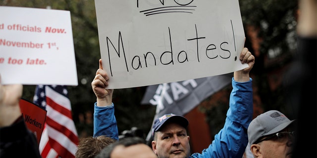 A demonstrator protests COVID-19 mandates.