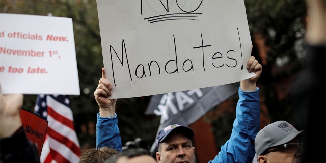 A demonstrator protests COVID-19 mandates.