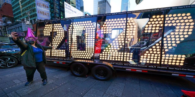A woman poses for a selfie in front of a 2022 sign displayed in Times Square, New York City, on Monday of this week. On New Year's Eve (and every day and night of the year), none of us should even think of getting behind the wheel of a car or truck if we've been drinking. 