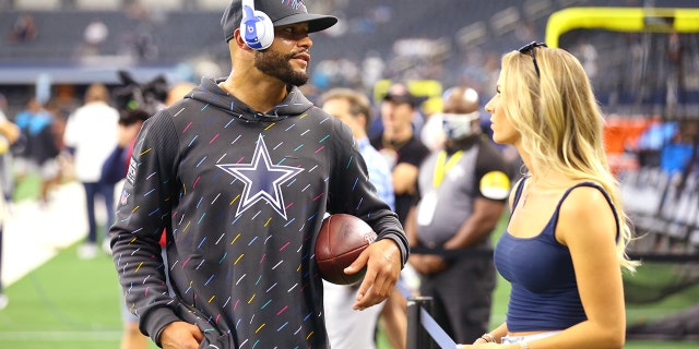 Dak Prescott #4 of the Dallas Cowboys talks with Natalie Buffett on the field before the game against the Carolina Panthers at AT&T Stadium on October 03, 2021 in Arlington, Texas.