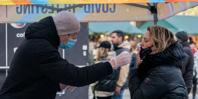 A person has a nasal swab applied for the coronavirus disease (COVID-19) test taken at a mobile testing site in New York, U.S., December 3, 2021.