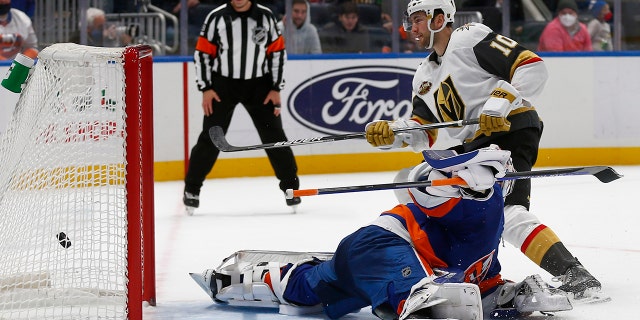 Vegas Golden Knights' Nicolas Roy (10) scores the winning penalty shot past New York Islanders' goalie Ilya Sorokin during an NHL hockey game Sunday, Des. 19, 2021, in Elmont, N.Y..