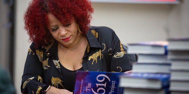 Nikole Hannah-Jones signs books for her supporters before taking the stage to discuss her book, "The 1619 Project: A New Origin Story" at an LA Times book club event in 2021. 