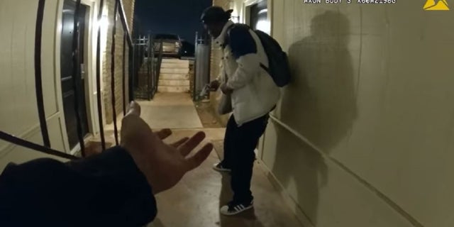 A suspect pulls out a gun in front of an Oklahoma City police officer.