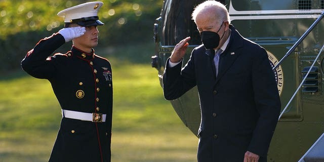 U.S. President Joe Biden salutes as he steps from Marine One upon his return to the White House in Washington, U.S., December 20, 2021.