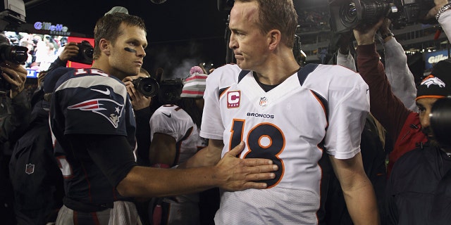 Denver Broncos QB Peyton Manning (18) with New England Patriots quarterback Tom Brady after a game at Gillette Stadium in Foxborough, Massachusetts.