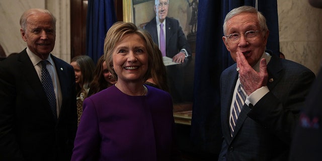 U.S. Senate Minority Leader Sen. Harry Reid (D-NV) (R), former Secretary of State Hillary Clinton (2nd L) and Vice President Joseph Biden (L)