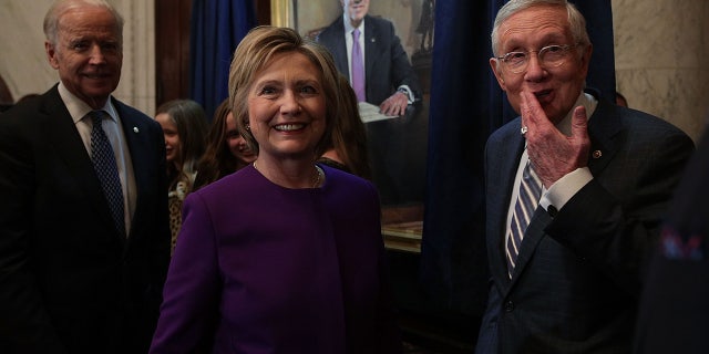 FILE 2016: Sen. Harry Reid, former Secretary of State Hillary Clinton  and then-Vice President Joseph Biden during Reid's leadership portrait unveiling ceremony on Capitol Hill. (Photo by Alex Wong/Getty Images)