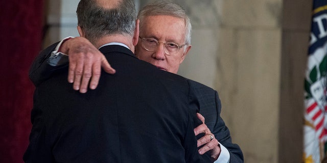 UNITED STATES - DECEMBER 08: Retiring Senate Minority Leader Harry Reid, D-Nev., right, hugs incoming Senate Minority Leader Charles Schumer, D-N.Y., during Reid's portrait unveiling ceremony in Russell Building's Kennedy Caucus Room, December 08, 2016.