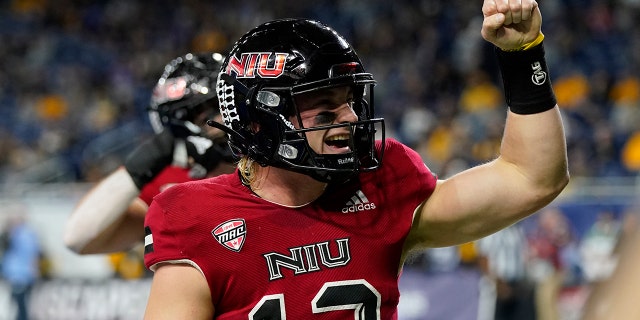 Northern Illinois quarterback Rocky Lombardi reacts toward fans after scoring on a 1-yard run during the first half against Kent State, Saturday, Dec. 4, 2021, in Detroit.