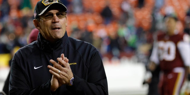 Nov 29, 2021; Landover, Maryland, USA; Washington Football Team head coach Ron Rivera celebrates while leaving the field after the game against the Seattle Seahawks at FedExField.