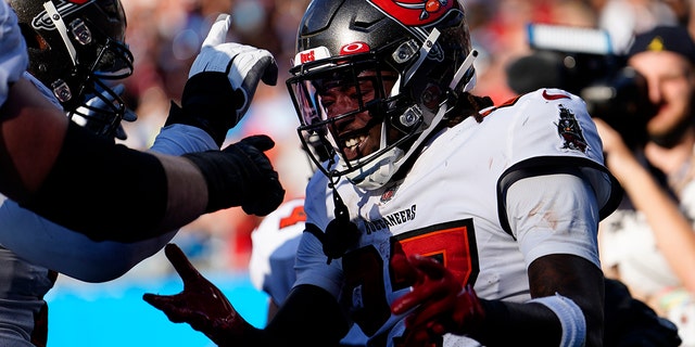 Tampa Bay Buccaneers running back Ronald Jones celebrates after scoring against the Carolina Panthers during the second half Sunday, Dec. 26, 2021, in Charlotte, N.C.