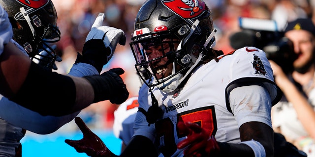 Tampa Bay Buccaneers running back Ronald Jones celebrates after scoring against the Carolina Panthers during the second half Sunday, Dec. 26, 2021, in Charlotte, N.C.