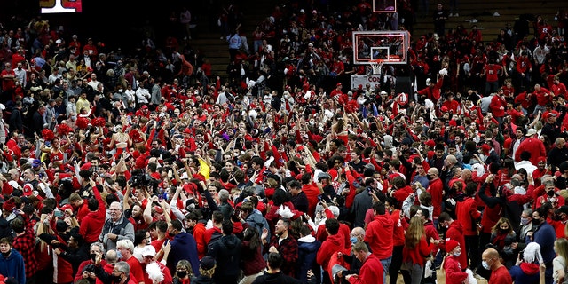 Fans gather on the court after Rutgers defeated Purdue 70-68 during an NCAA college basketball game in Piscataway, N.J., Thursday, Dec. 9, 2021.
