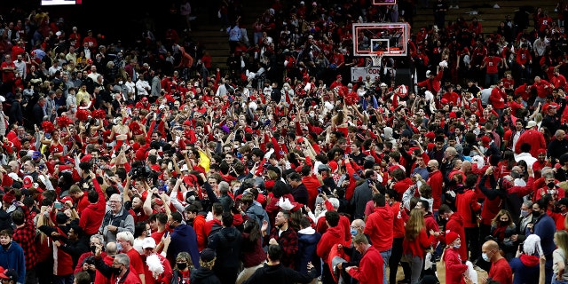 Fans gather on the court after Rutgers defeated Purdue 70-68 during an NCAA college basketball game in Piscataway, N.J., Thursday, Dec. 9, 2021.