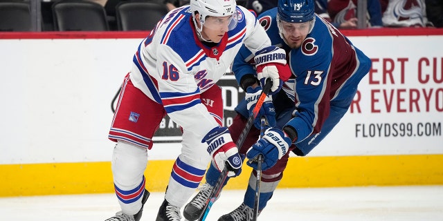 New York Rangers center Ryan Strome, left, passes the puck as Colorado Avalanche right wing Valeri Nichushkin defends in the second period of an NHL hockey game Tuesday, Dec. 14, 2021, in Denver.