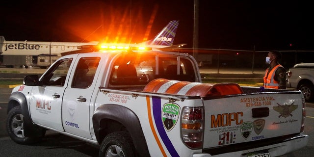 Police members of roadside assistance stand outside the Las Americas International Airport  on Wednesday. 