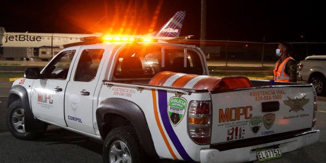 Police members of roadside assistance stand outside the Las Americas International Airport on Wednesday.