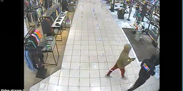Photo of security guard getting hit with bear spray in a Nov. 24 robbery by a gang of thieves in Los Angeles. Six suspects, including four minors, have been arrested in connection with other flash mob robbery incidents, the Los Angeles Police Department said Thursday.